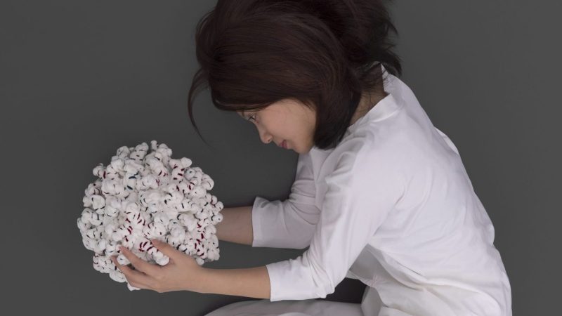 Tame is to Tame, 2016, Image of a girl holding a norovirus doll, Pei-Ying Lin.